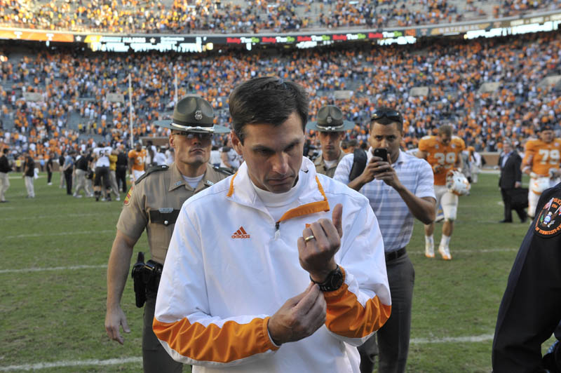 Derek Dooley walks off the field.